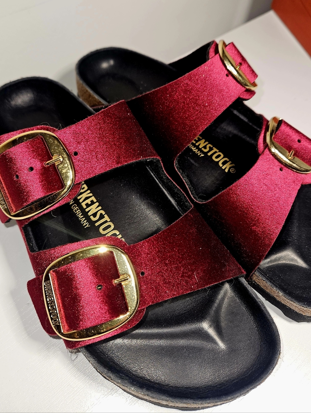 New Arizona Birkenstock Velvet Two-Strap Slides in Burgundy with Gold Buckles.